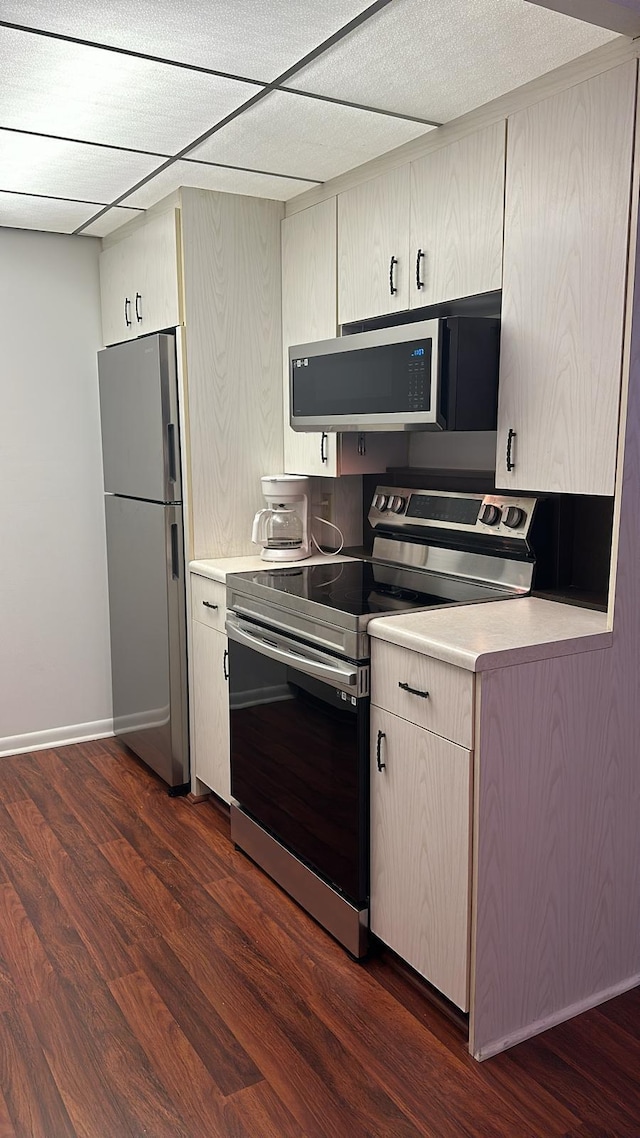 kitchen featuring appliances with stainless steel finishes and dark hardwood / wood-style flooring