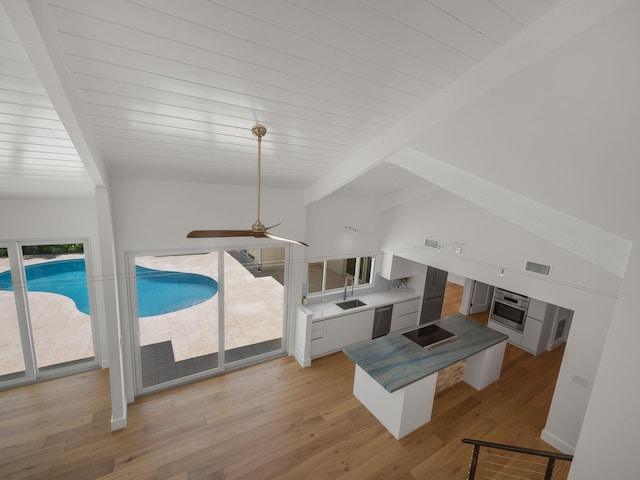 living room with beam ceiling, ceiling fan, sink, and light hardwood / wood-style flooring