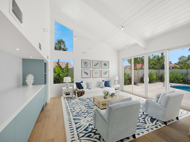 living room featuring wood ceiling, french doors, beamed ceiling, high vaulted ceiling, and light hardwood / wood-style flooring