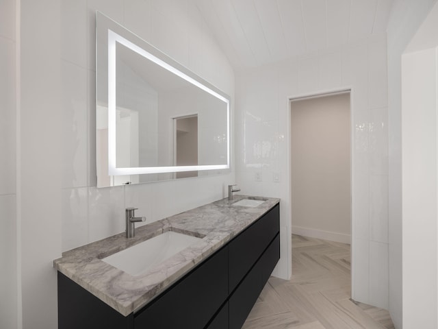 bathroom featuring vanity, parquet floors, and vaulted ceiling