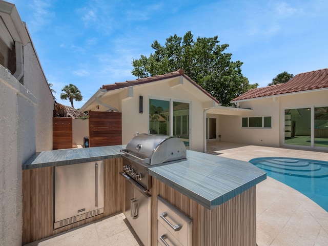 view of patio featuring an outdoor kitchen and grilling area