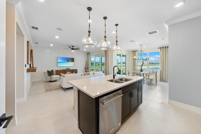 kitchen featuring dishwasher, sink, an island with sink, pendant lighting, and ceiling fan with notable chandelier