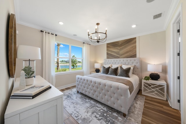 bedroom featuring an inviting chandelier, a water view, crown molding, and dark wood-type flooring