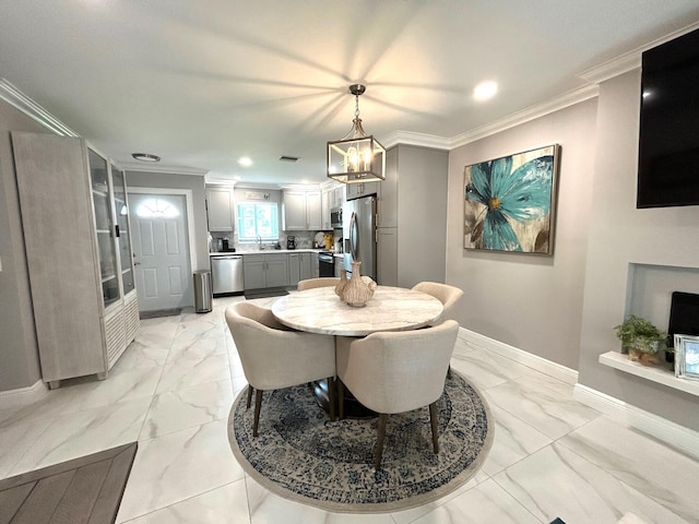 dining space with ornamental molding, sink, and a notable chandelier