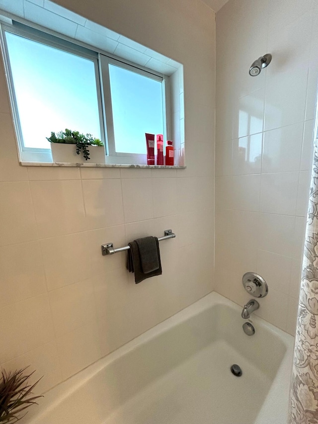 bathroom featuring shower / bathtub combination with curtain