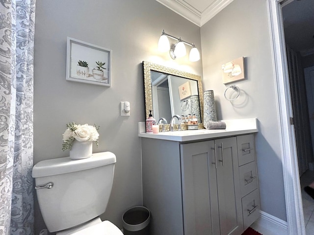 bathroom featuring crown molding, vanity, and toilet