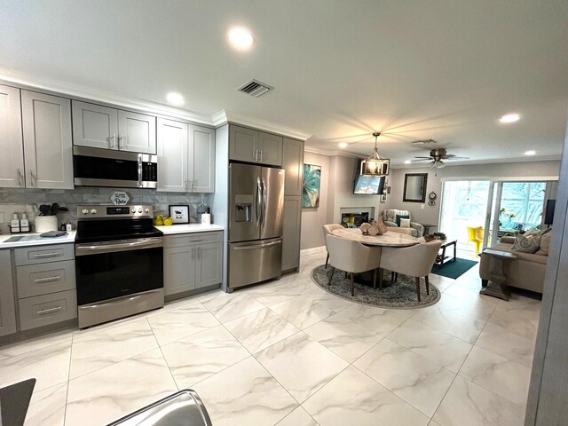 kitchen with gray cabinets, tasteful backsplash, stainless steel appliances, and ceiling fan