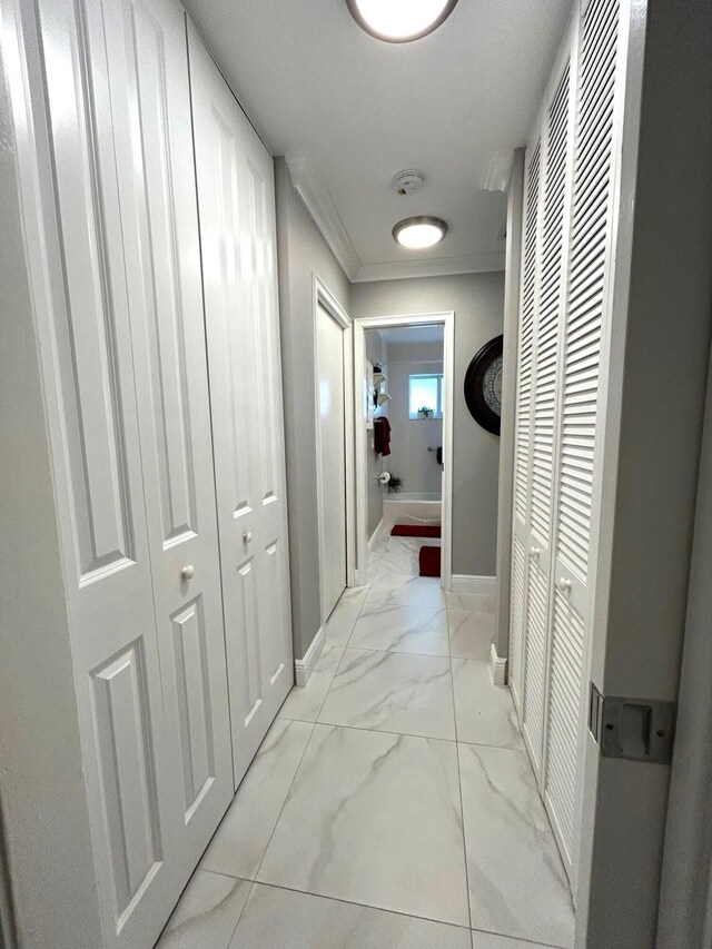 hallway featuring crown molding