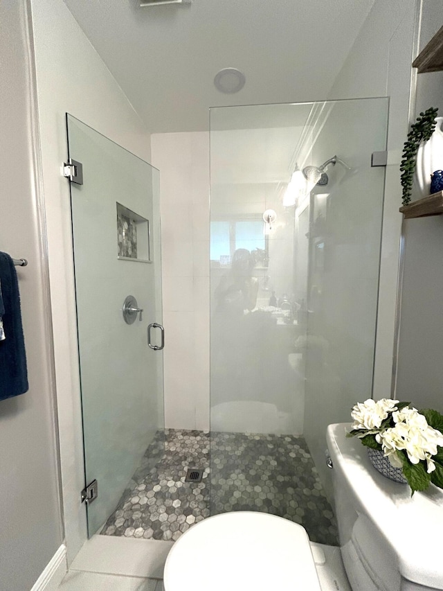 bathroom with toilet, an enclosed shower, vaulted ceiling, and tile patterned floors