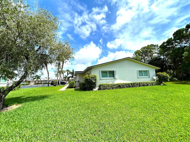 view of home's exterior with a lawn