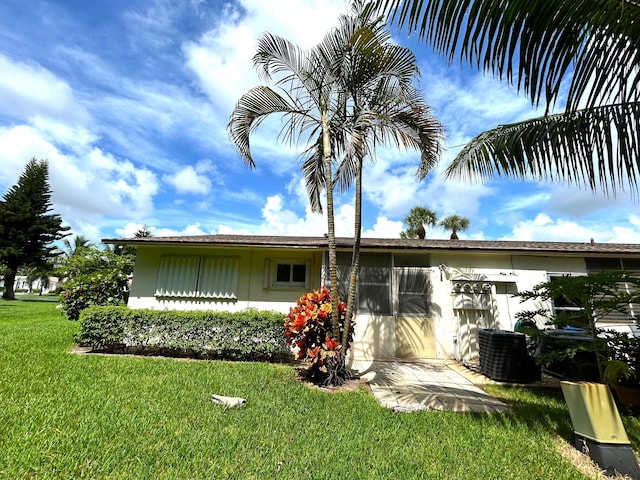 rear view of property with a yard