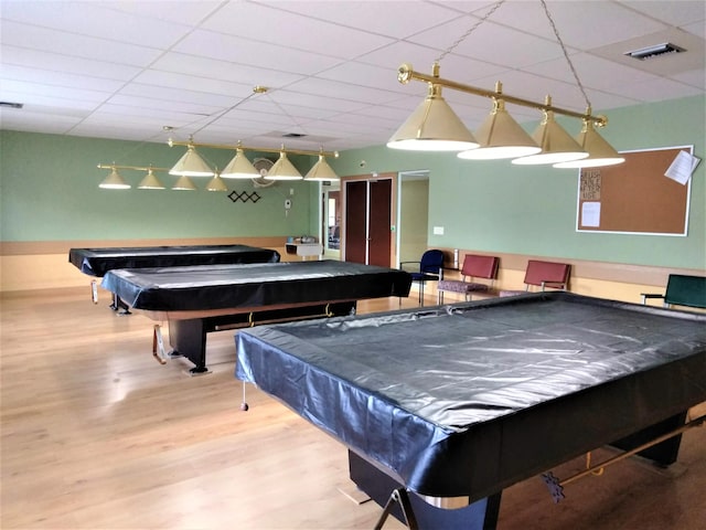 rec room with a paneled ceiling, billiards, and wood-type flooring