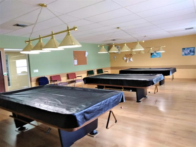 game room with billiards, wood-type flooring, and a drop ceiling