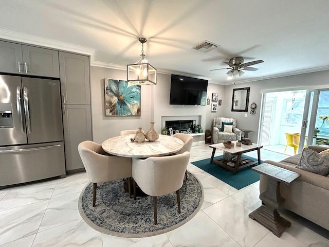 interior space featuring ceiling fan with notable chandelier and ornamental molding