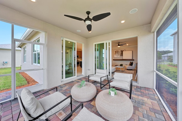 sunroom with ceiling fan