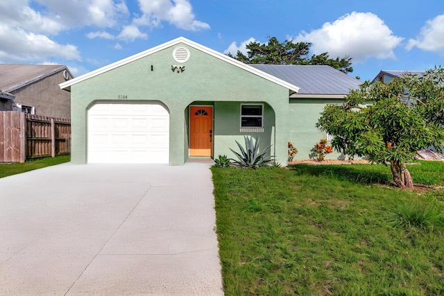 single story home with a garage and a front lawn