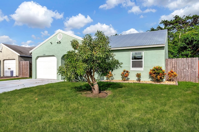 view of front of property with a garage and a front yard