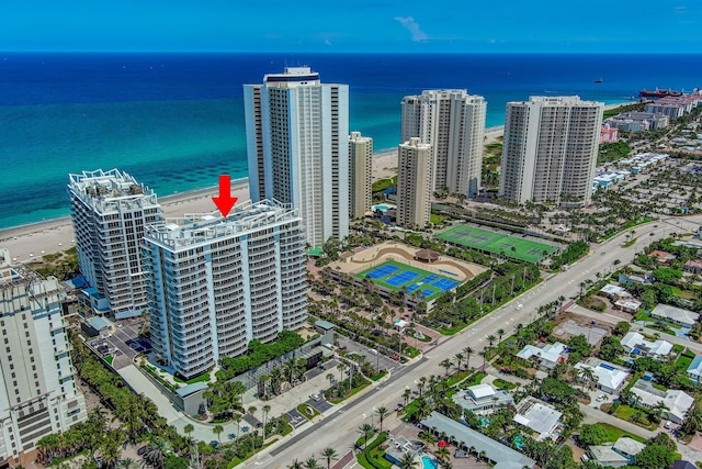 drone / aerial view with a water view and a view of the beach