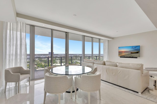 dining space featuring light tile patterned floors and expansive windows