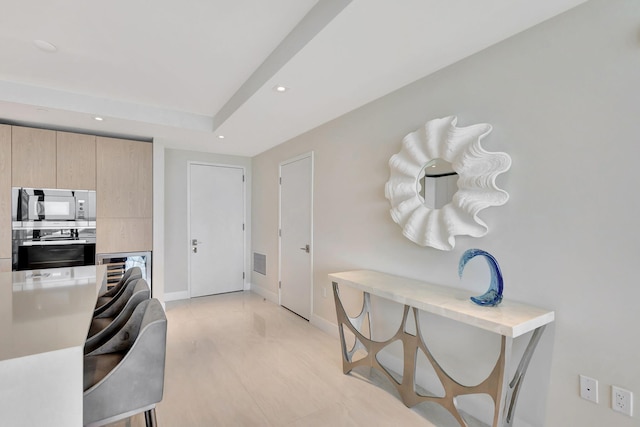 kitchen featuring light brown cabinetry and stainless steel appliances