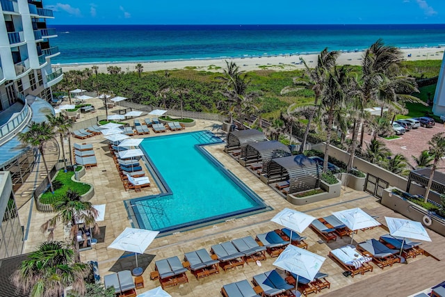 drone / aerial view featuring a water view and a beach view