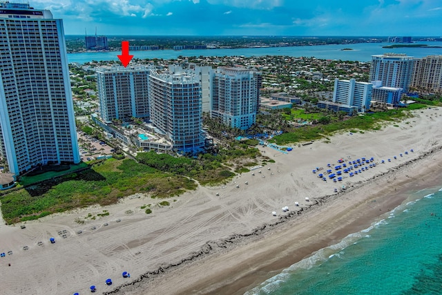 drone / aerial view with a beach view and a water view