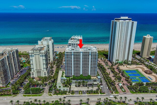 bird's eye view with a water view and a beach view