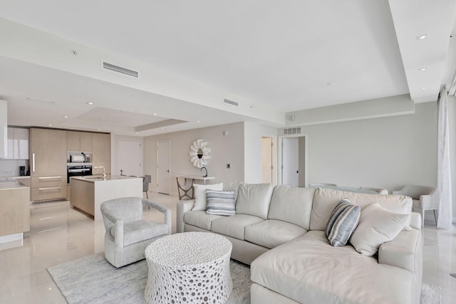 living room with a tray ceiling