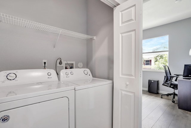 washroom featuring washer and dryer and light hardwood / wood-style flooring