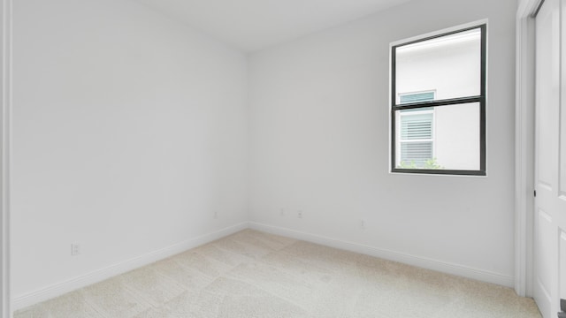 spare room with light colored carpet