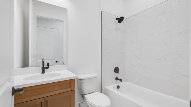 full bathroom featuring vanity, tiled shower / bath combo, and toilet