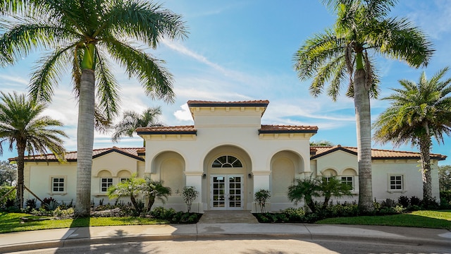 mediterranean / spanish-style home with french doors