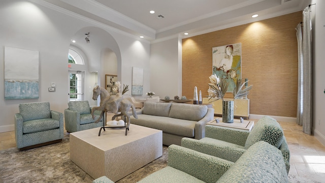 living room featuring a high ceiling and crown molding