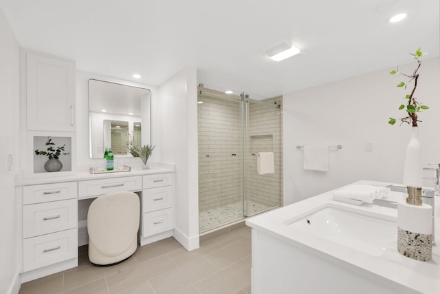 bathroom with vanity, walk in shower, and tile patterned flooring