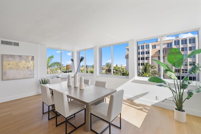 dining space with light hardwood / wood-style flooring and plenty of natural light