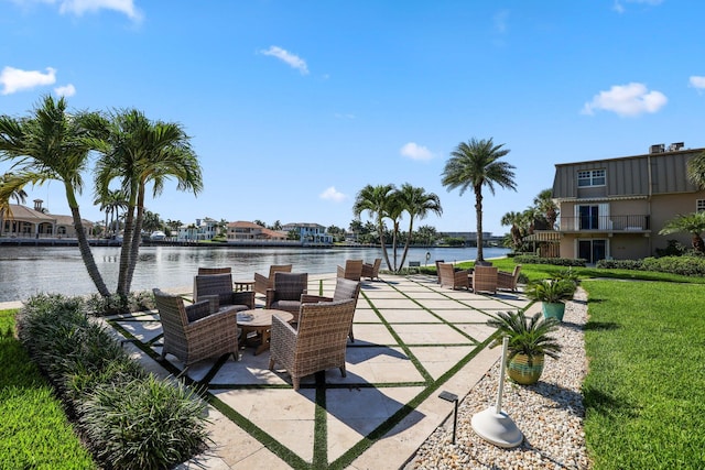 view of home's community with a water view and a lawn