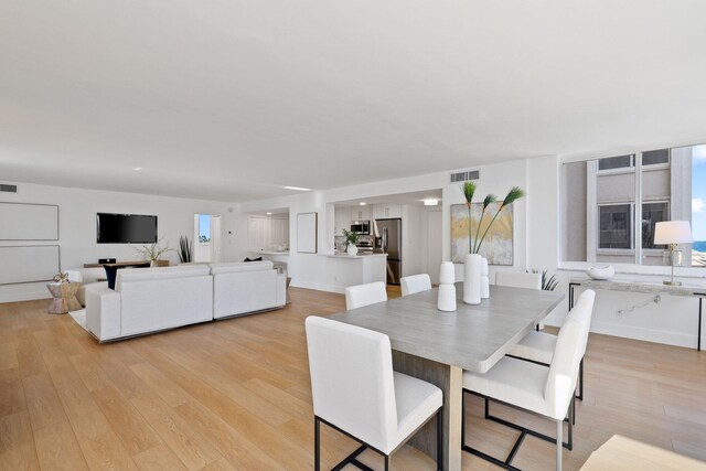 dining space with light hardwood / wood-style flooring