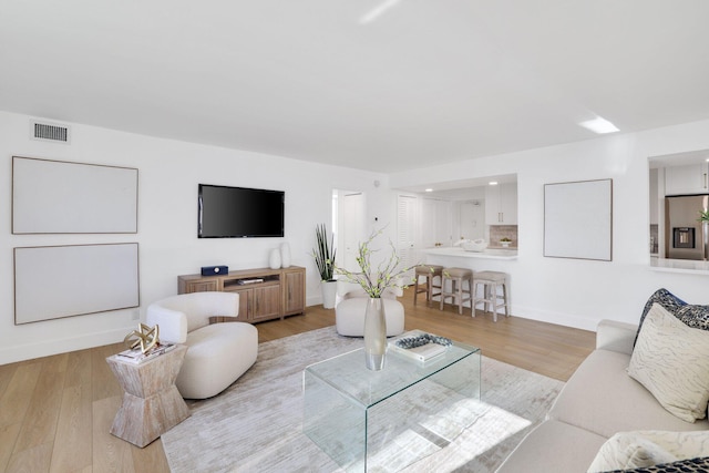 living room with light hardwood / wood-style floors