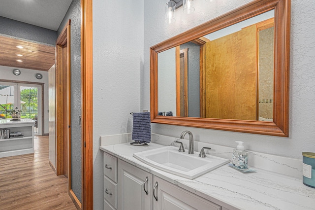 bathroom with hardwood / wood-style flooring and vanity