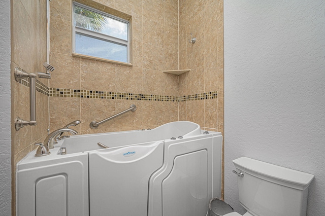 bathroom with toilet and a bathing tub