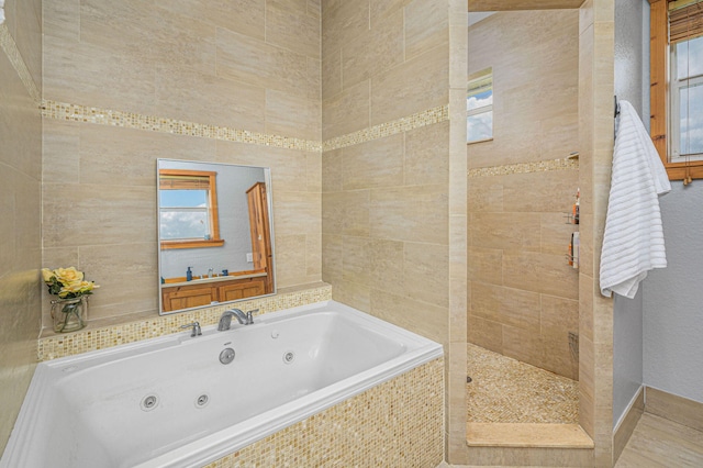 bathroom featuring independent shower and bath and tile walls