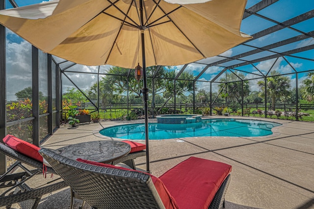 view of pool with a lanai, a patio, and an in ground hot tub