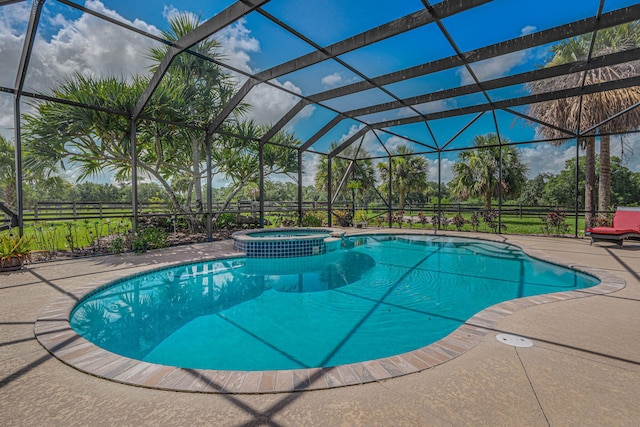 view of pool featuring an in ground hot tub, a lanai, and a patio