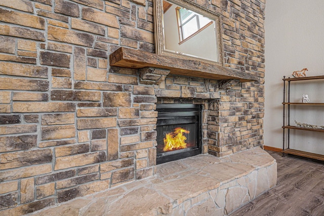 interior details with a large fireplace and hardwood / wood-style flooring