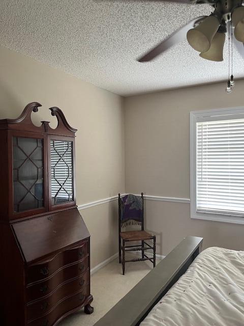 carpeted bedroom featuring a textured ceiling