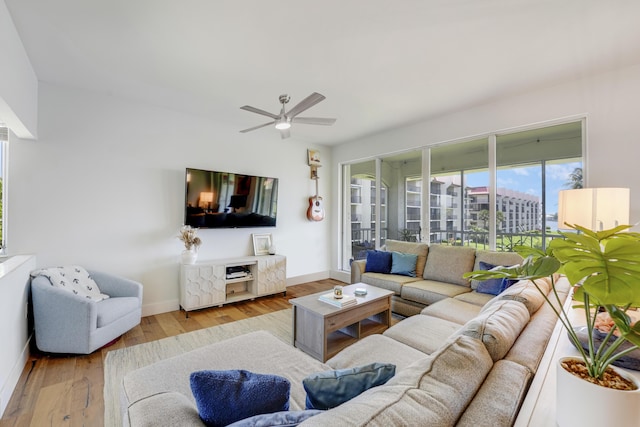 living room featuring ceiling fan and light hardwood / wood-style floors