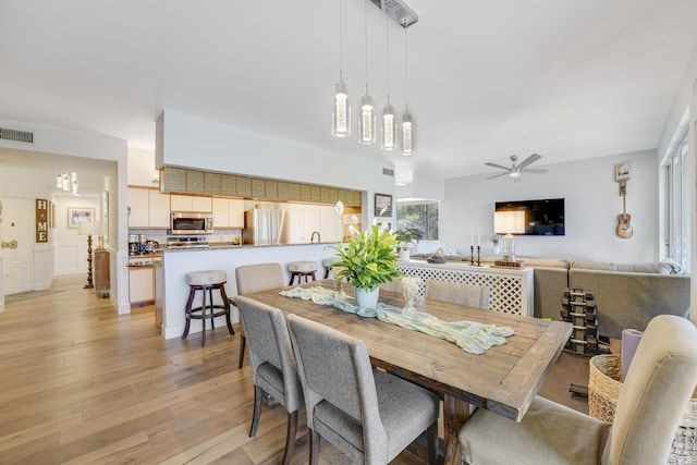 dining room featuring light hardwood / wood-style flooring and ceiling fan