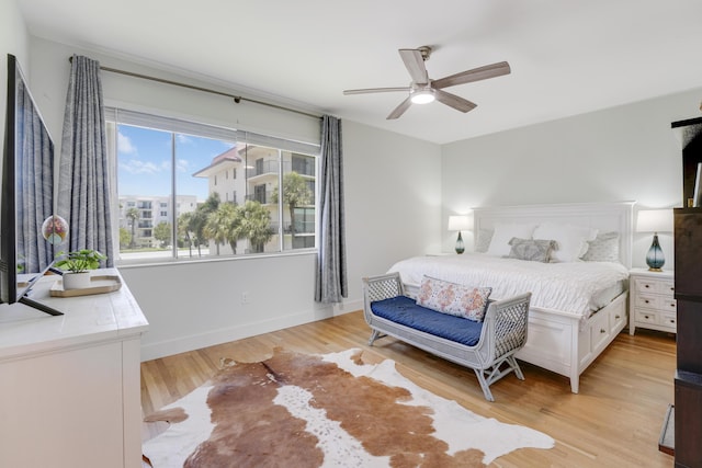 bedroom with ceiling fan and light hardwood / wood-style flooring