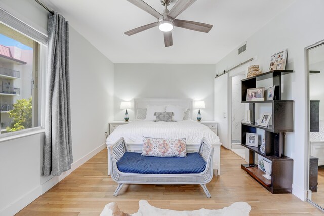 bedroom with ceiling fan and light hardwood / wood-style flooring