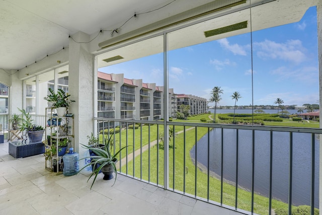 unfurnished sunroom with a water view